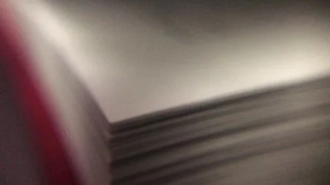 The edge of a large book is turned over by hand. Stock Footage 287676161