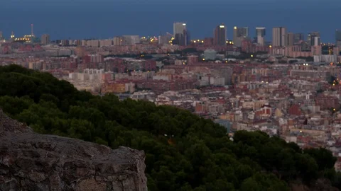 Edge of old building remains on foreground, dim green slope and blurred city Vídeos de archivo 103386048