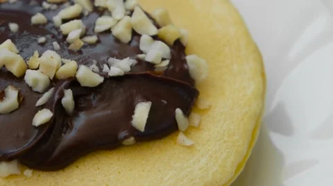 Edge of pancake with chocolate cream and nuts Stock Footage 54339586
