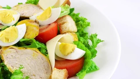 Edge of plate with Caesar salad, copy space in right side, chicken, eggs Stock Footage 73508336