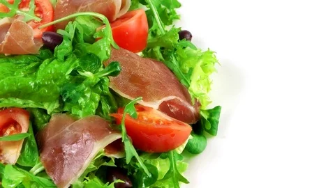 Edge of plate with Hamon salad, copy space in right side, ham, lettuce leaf Stock Footage 73508162
