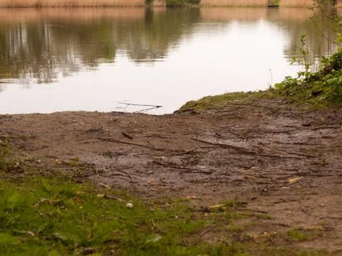 The Edge of the River Bank at a Low Angle on a Wet and Rainy Spring Day Stock Photos