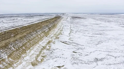 Edge of a sandy cliff of the snow-covered desert in winter. Western Kazakhstan Stock Footage 93837843