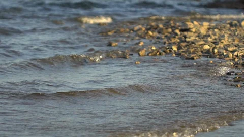 The edge of the sea, pebble beach, pebbles. abstract background. Pebble beach Stock Footage 99890154