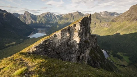 On the edge, sharp mountain peak on warm light Stock Footage 122993996
