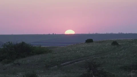 The edge of the sun at sunset over the fields Stock Footage 101950352