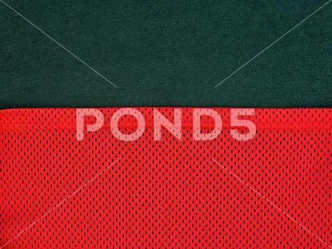 Edge texture bright red mesh fabric and dark green. Stock Photos