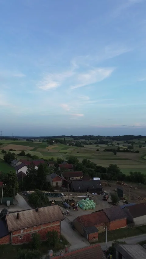 Edge of Village with Open Fields Aerial View Drone Footage 動画素材 337023742