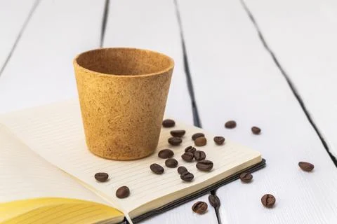Edible coffee cup with roasted beans on white background Photos
