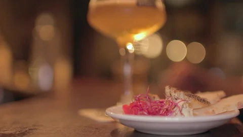 Edible Crickets Tapas Plate with Blurred Craft Beer Glass at Bar Counter Stock Footage 346236572