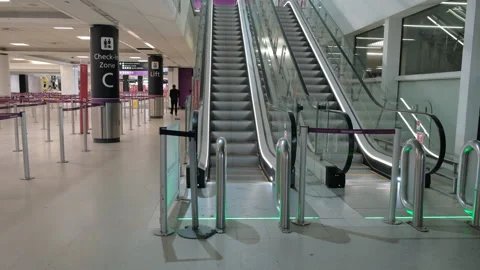 Edinburgh Airport interior shows escalators and empty check-in area Stock Footage 301871069