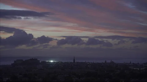 Edinburgh skyline beneath pink dawn clouds in Scotland Stock Footage 340646440