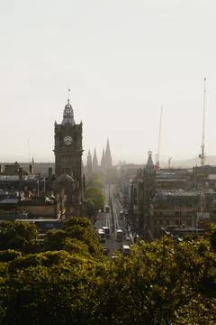 Edinburgh skyline with historic clock tower, busy street, spires and cranes Stock Photos