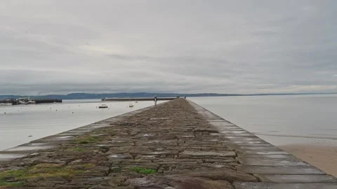 Edinburgh Wardie Bay Person Walking on the Eastern Breakwater Stock Footage 237780098