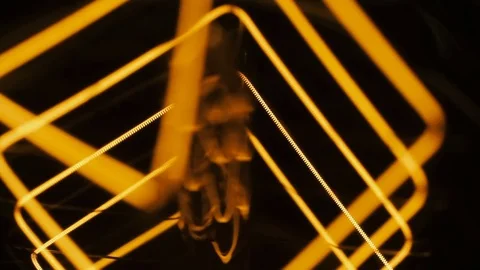 Edison bulb on a black background. Spiral of incandescence close-up Stock Footage 78133316