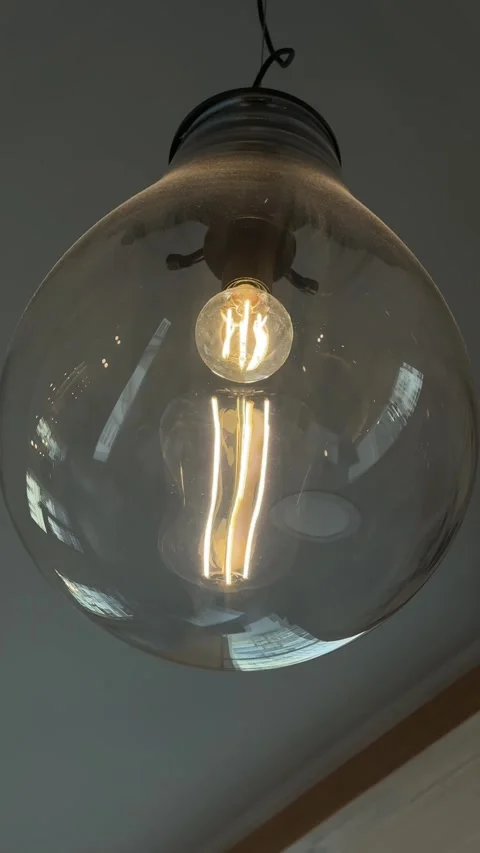Edison bulb hanging, a large clear glass fixture with a vintage-style Stock Footage 336311046