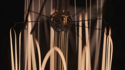 Edison lamp base on black background lights up close-up in slow motion Stock Footage 143539973