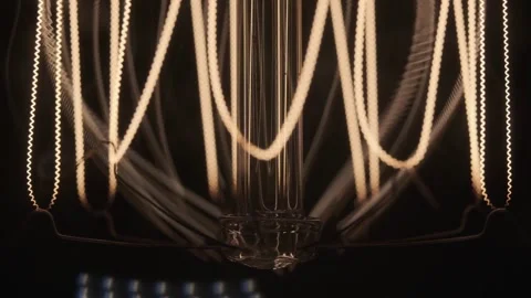 Edison lamp base on black background lights up close-up in slow motion Stock Footage 143540003