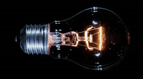 Edison lamp light bulb blinking over black, macro view Video stock 64073272