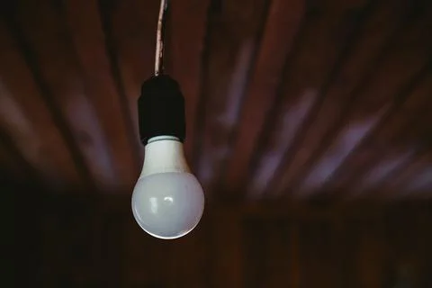 Edison light bulb on dark background Stock Photos
