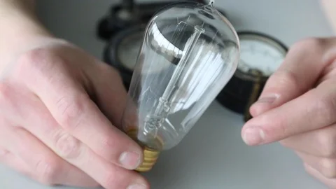 Edison light bulb held in hand Stock Footage 112635348