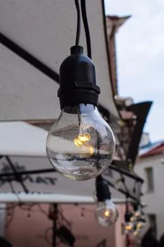 Edison-Style String Lights Under an Awning in Tallinn Old Town Stock-Fotos