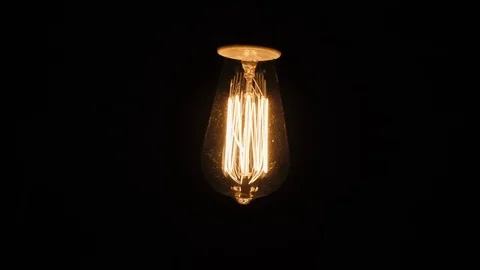 Edison's lamp shines in the dark. Background with electric llamas Stock Footage 123412383