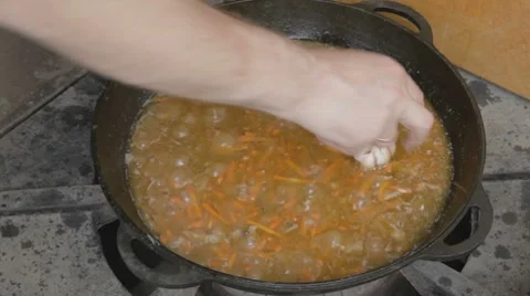 EDIT Adding garlic into stewing pork with carrot Stock-Footage 7753005