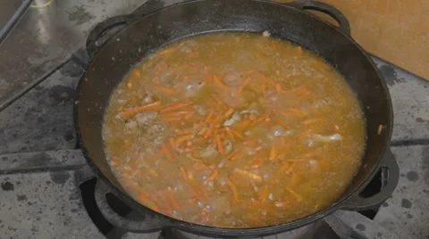 EDIT Adding salt to stewing pork slices and chopped carrot Stock-Footage 7753006