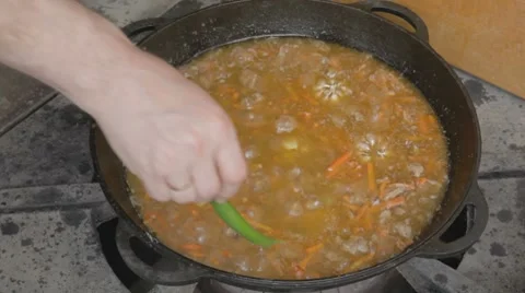 EDIT Adding spicy green peppers into stewing pork with carrot Stock Footage 7753008