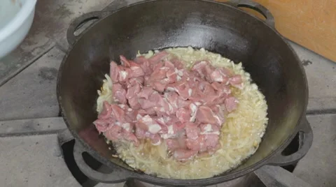 EDIT Mixing fresh cut pork with fried onion Stock Footage 7752946