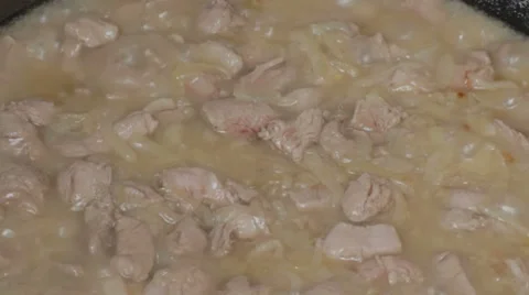 EDIT Sliced onions and cut pork stewing in the cauldron Stock Footage 7752966