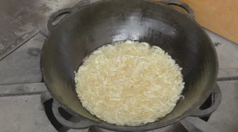 EDIT Spreading fresh cut pork on fried onions Stock Footage 7752937