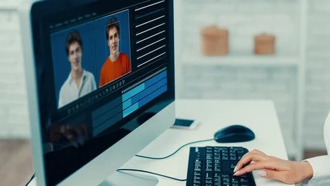 Editing a deep fake video on a computer with two faces and color settings Stock Photos