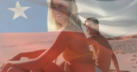 Editor applying flag overlay over woman in yellow bikini sitting on shore, man Fotos Stock