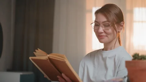 Editor examines pages with concentration in cozy space. Female writer Stock Footage 345517956