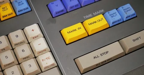 An Editor Presses Mark In and Mark Out Buttons on an Edit Controller Video stock 64055097