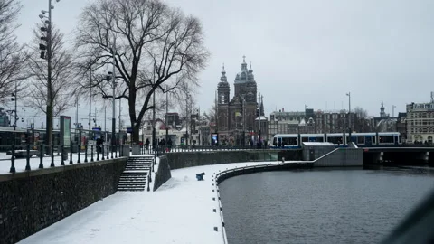 Editorial 4K Amsterdam Central Station in Snow as Tram Departs Stock Footage 338425965