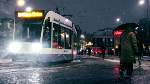 Editorial 4K Tram Driving Toward Amsterdam Central Station on Snowy Night Stock Footage 338427579