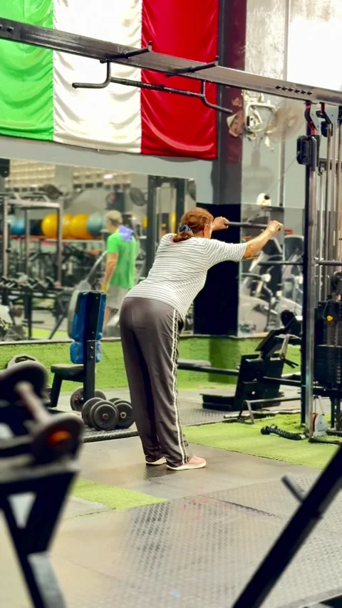 Editorial: 70-Year-Old Senior Woman Training on Treadmill - Active Lifestyle Stock Footage 330662628