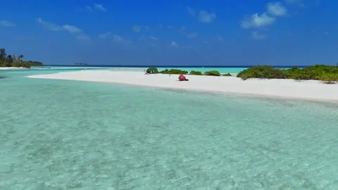 EDITORIAL: Aerial Low Drone Shot of White Sandbank Beach with Bean Bag Chair in Stock Footage 344133074