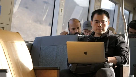 Editorial: Asian Man On Computer Riding Subway 스톡 동영상 121162987