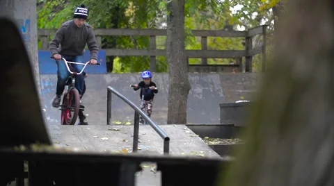 EDITORIAL Boy going rail slide on BMX bike. Slow motion 400fps in city park Stock Footage 57114970