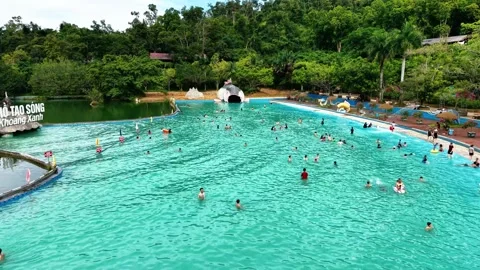 Editorial close up drone tracking along crowded thermal hot spring pool 4K Stock Footage 341551370