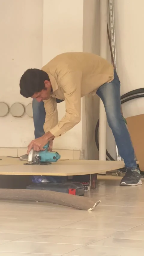 Editorial: Construction Worker Cutting Wood Board with Circular Saw Stock Footage 330802565