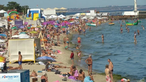 Editorial: Crowded sunny beach. Many people at seaside. Nice vacation spot. 動画素材 122837448