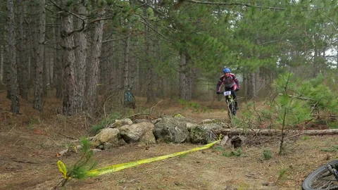 Editorial. The cyclist rides through the big rocks and drives on. Stock Footage 108519764
