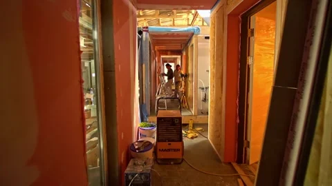 Editorial dolly shot moving through a prefab housing construction site with Stock Footage 332919553
