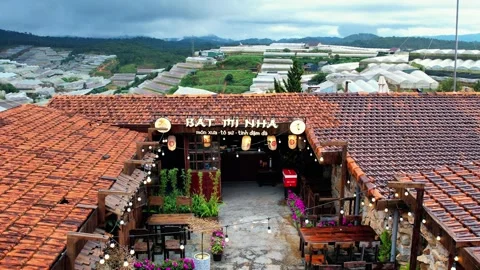 Editorial drone backward tracking past outdoor seating at Da Lat cafe 4K Vídeo Stock 341541841