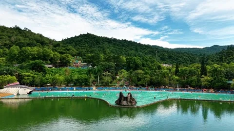 Editorial drone tracking over turquoise swimming pool at Ba Vi water park 4K Stock Footage 341551333